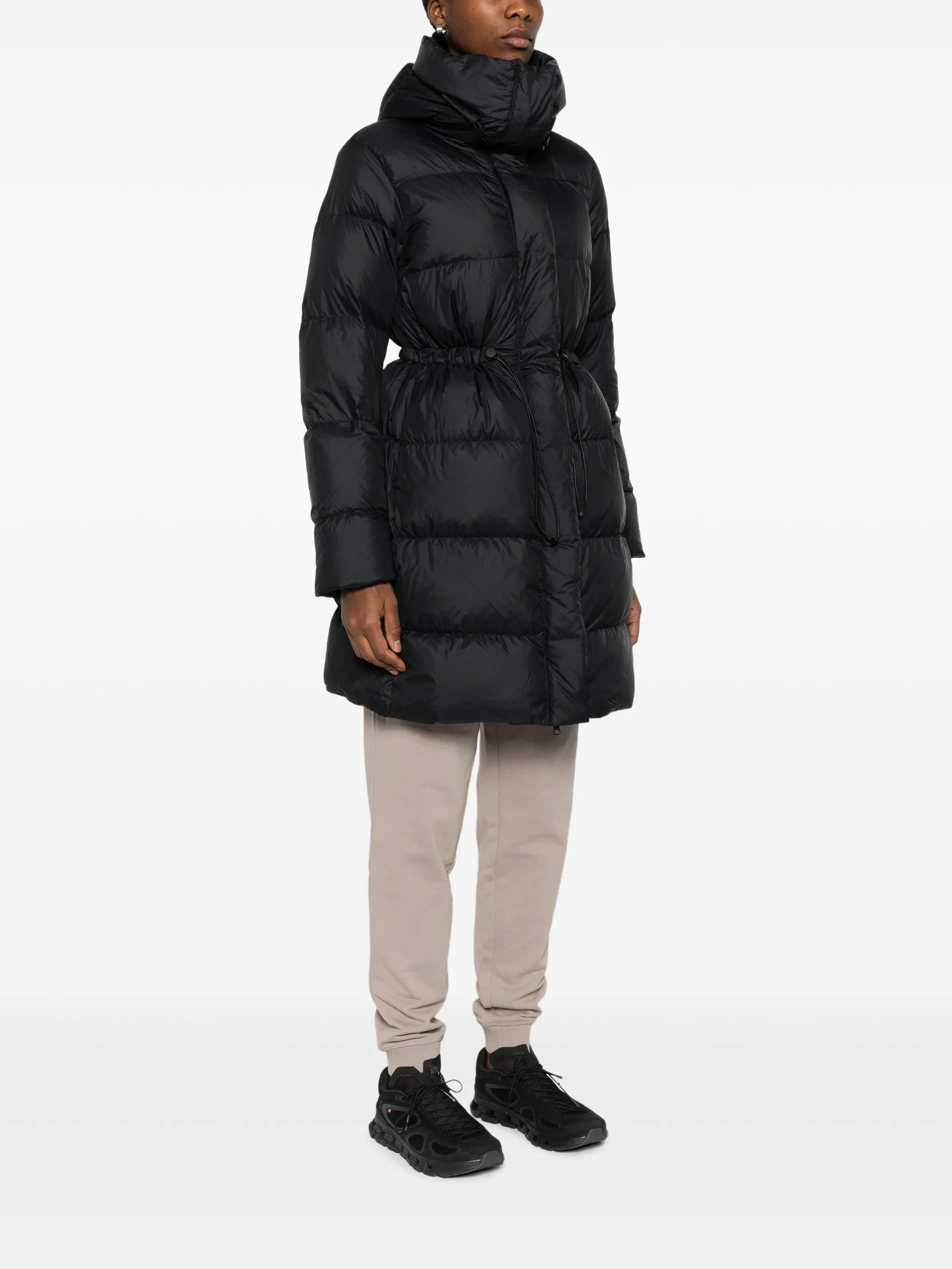 Black coat  worn by a person, showing the coat's fit