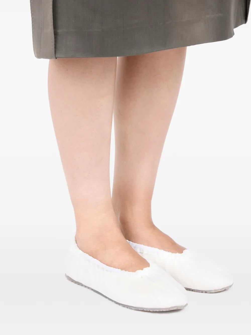 white sneakers worn by a person, showing the sneakers  fit