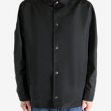 Black jacket worn by a person, showing the jacket fit