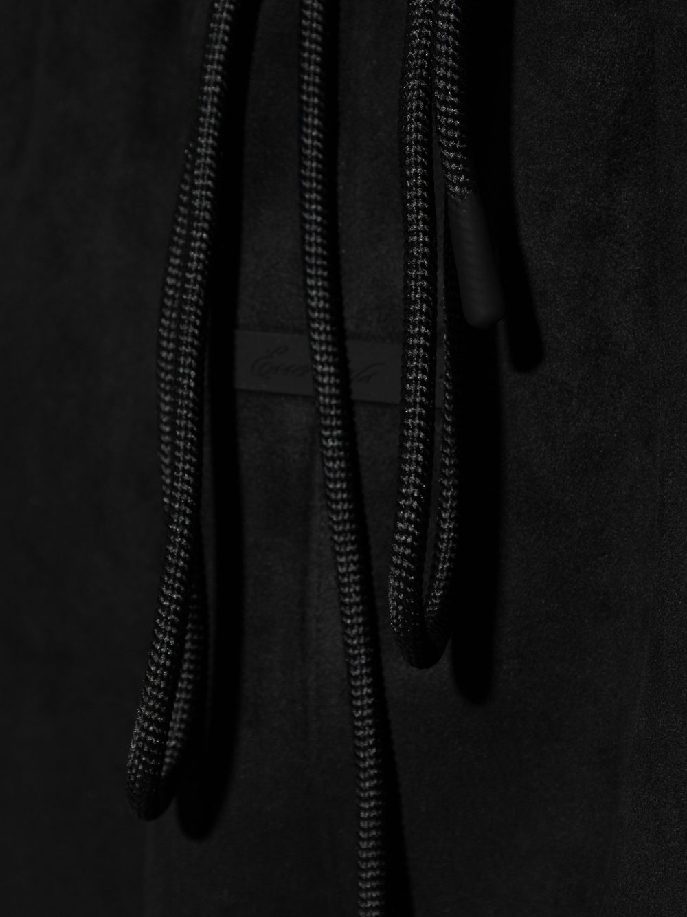 Close up of black pants, showing texture of the cotton fabric