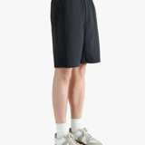 Black short worn by a person, showing the short's fit