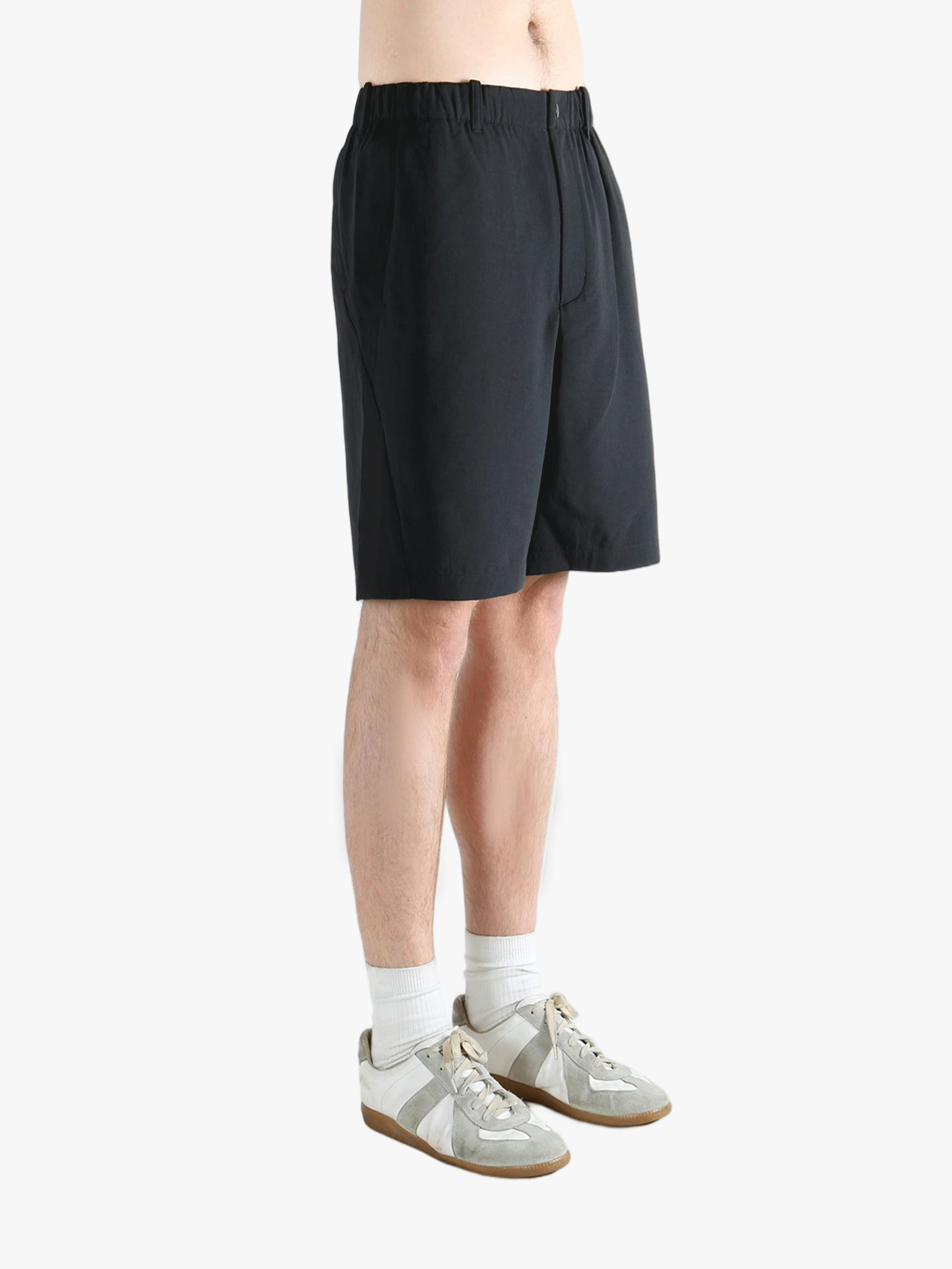 Black short worn by a person, showing the short's fit