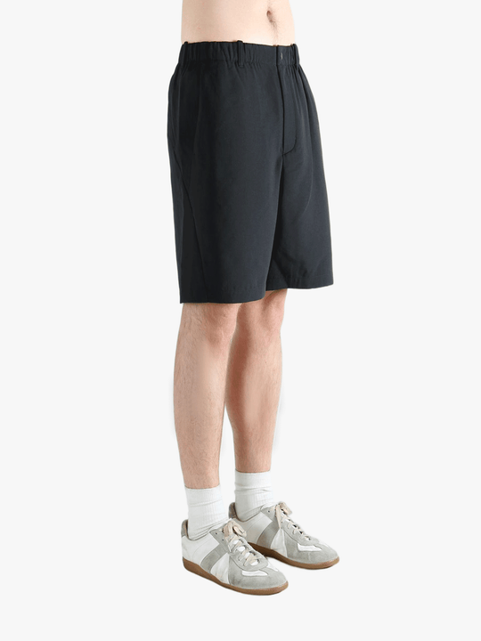 Black short worn by a person, showing the short's fit