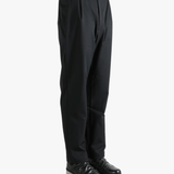Black pants worn by a person, showing the pants' fit