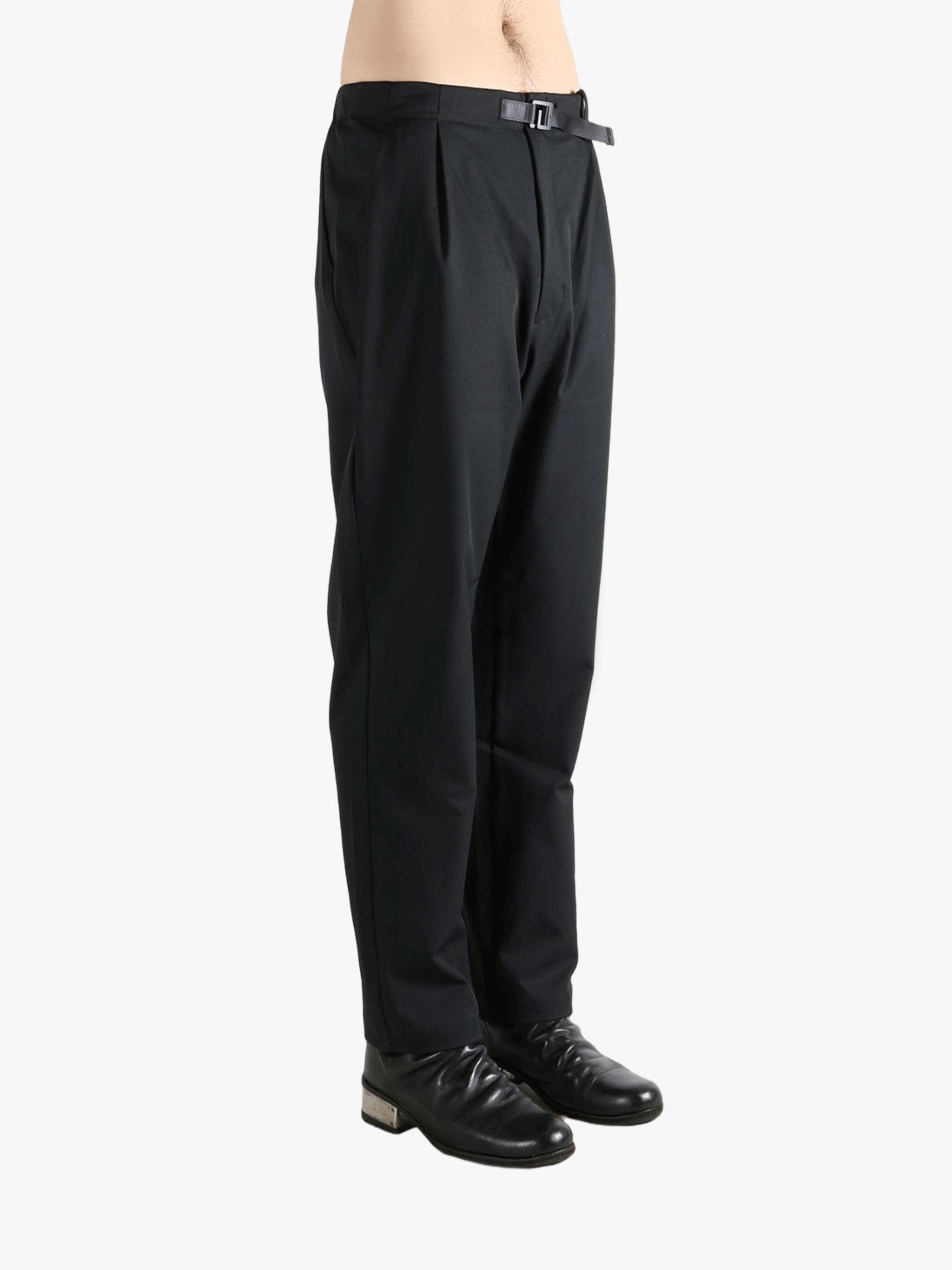 Black pants worn by a person, showing the pants' fit