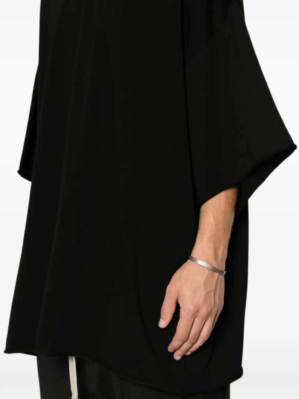 Black t-shirt worn by a person, showing the t-shirt fit