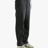 Grey pant worn by a person, showing the pant's fit