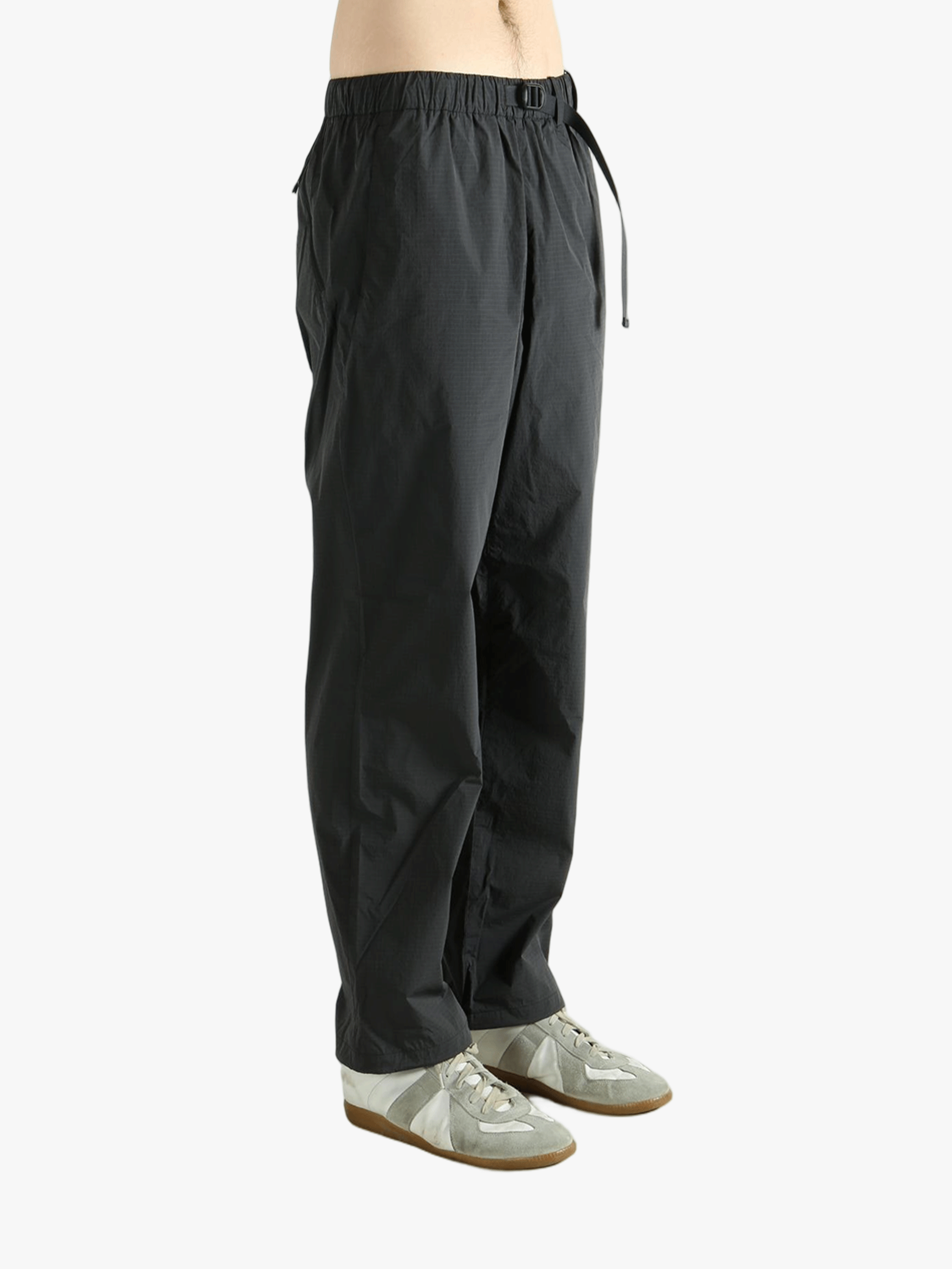 Grey pant worn by a person, showing the pant's fit