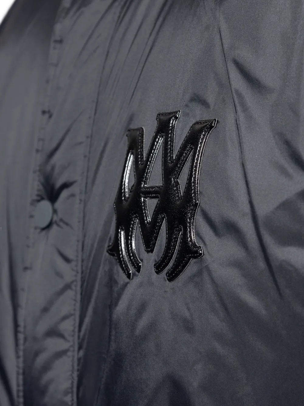 Close up of the black jacket, showing texture of the nylon fabric