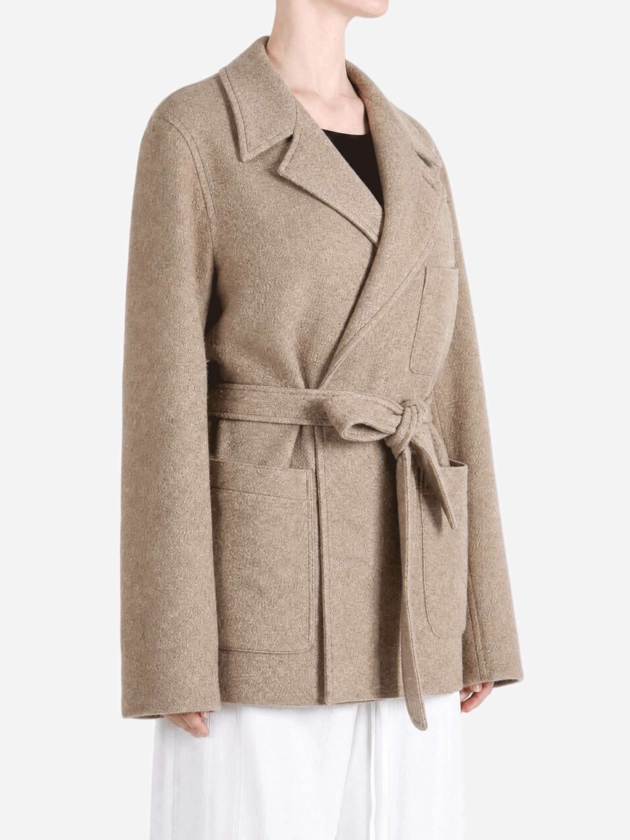 Tan jacket worn by a person, showing the jacket fit