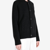 Black knitwear worn by a person, showing the knitwear fit