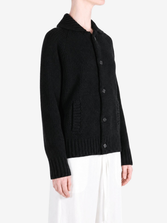 Black knitwear worn by a person, showing the knitwear fit