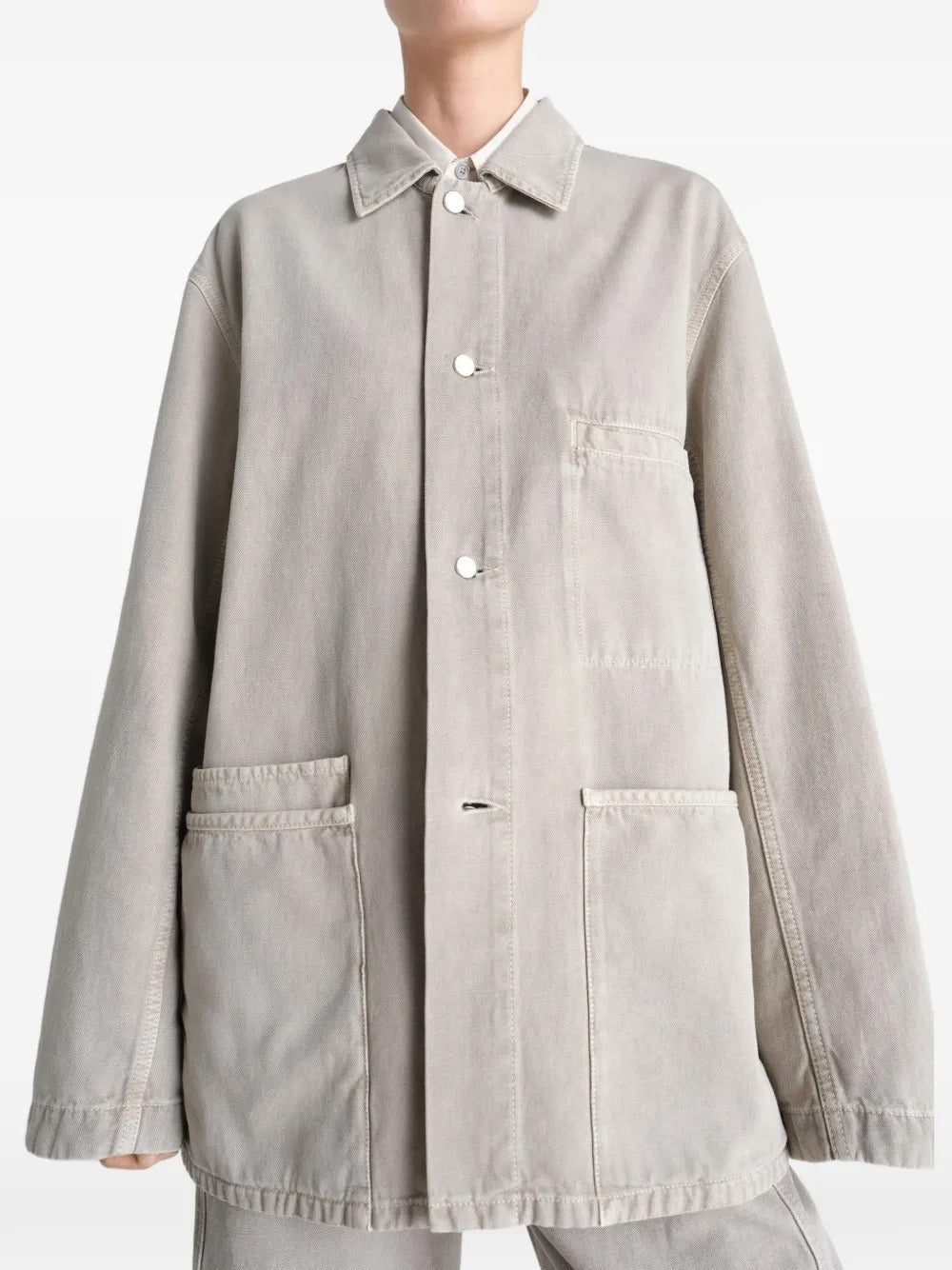 White shirt worn by a person, showing the shirt's fit