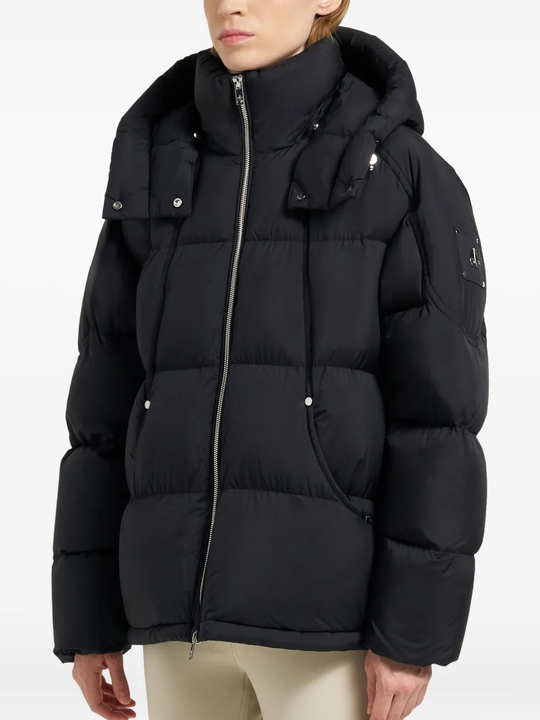 Black coat worn by a person, showing the coat fit