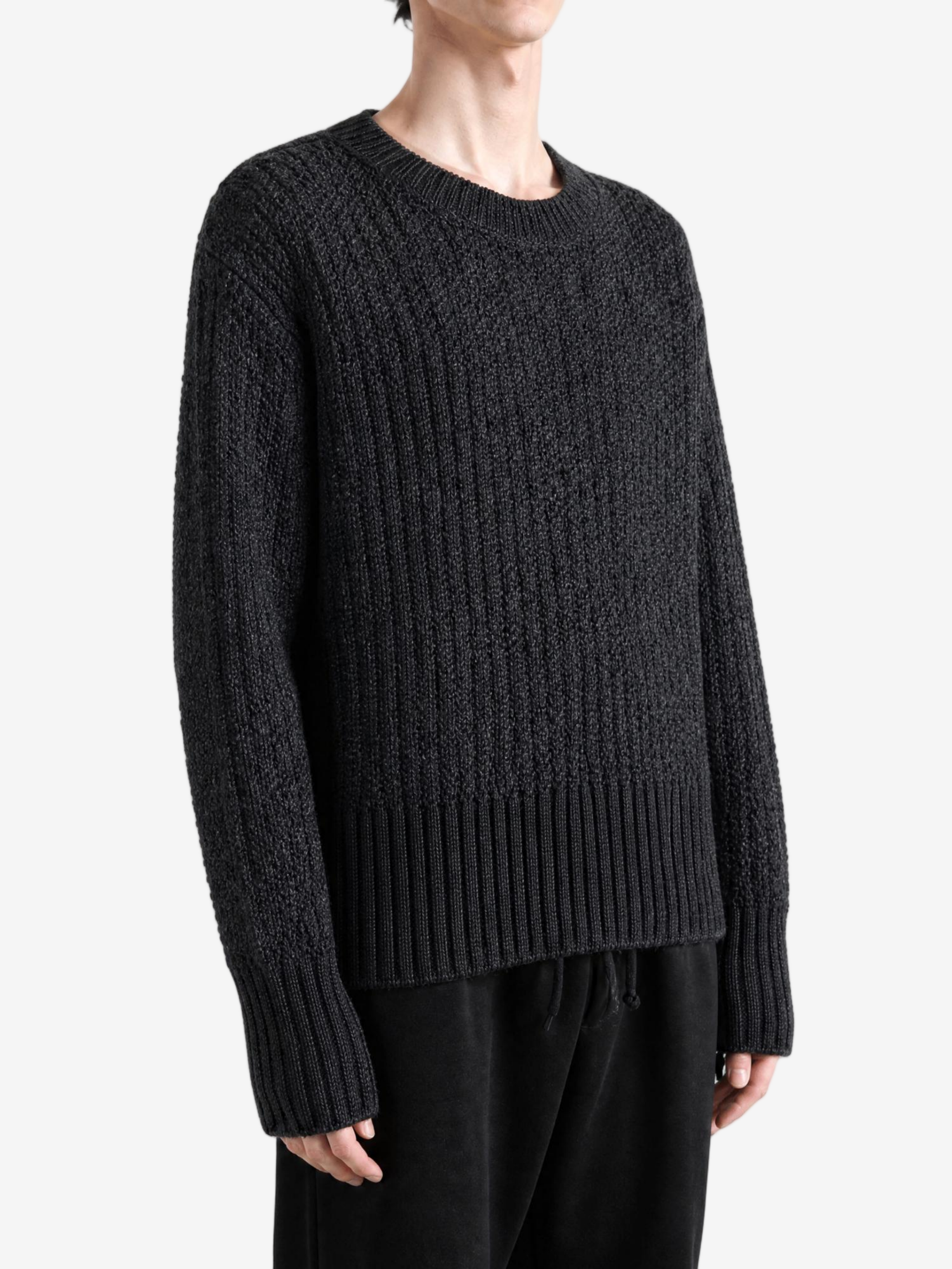Grey knitwear worn by a person, showing the knitwear fit