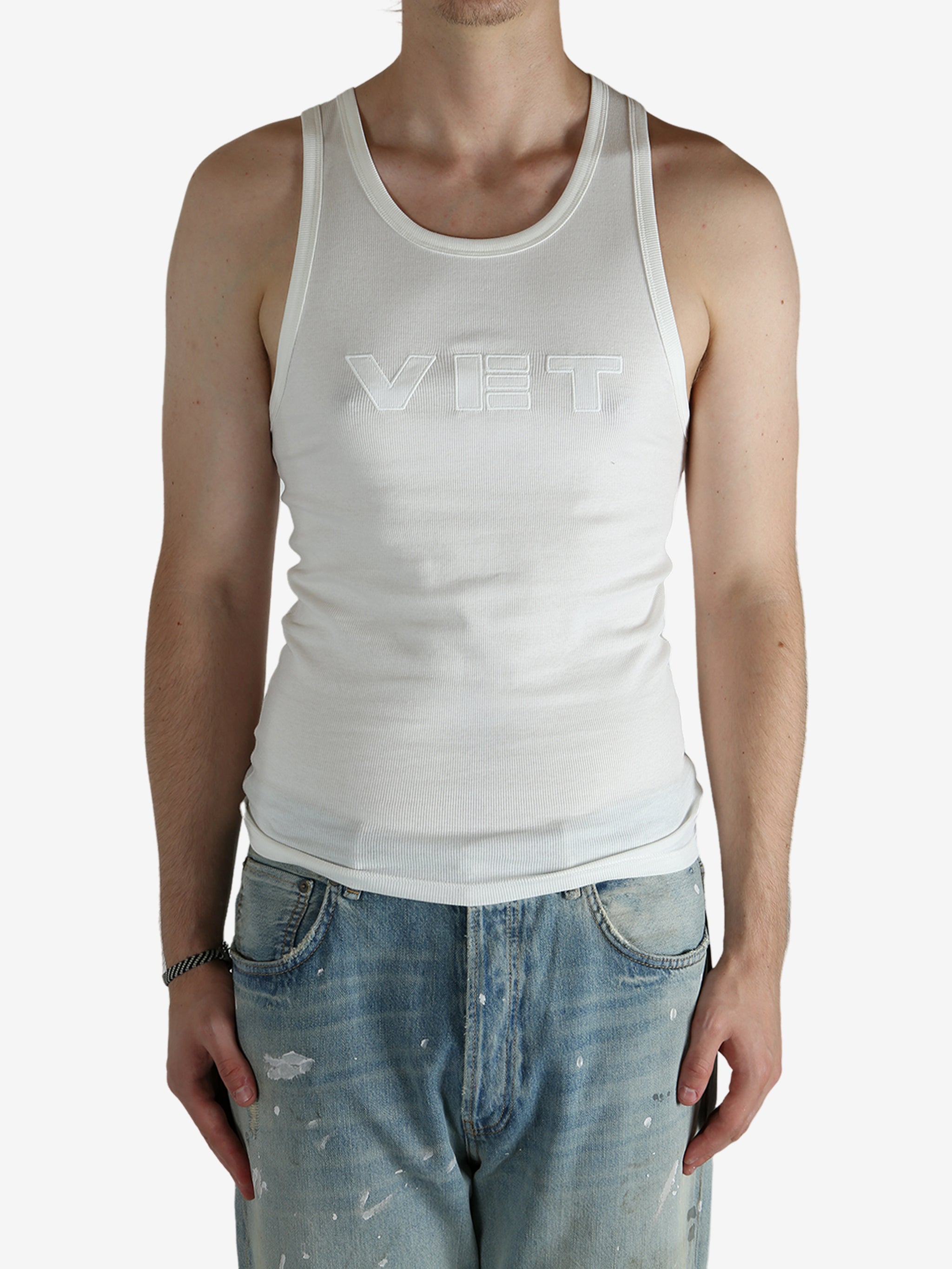 White top worn by a person, showing the top's fit
