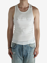 White top worn by a person, showing the top's fit