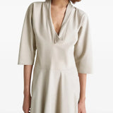 Close up of tan dress, showing texture of the cow leather fabric