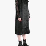 Black coats worn by a person, showing the coat's fit