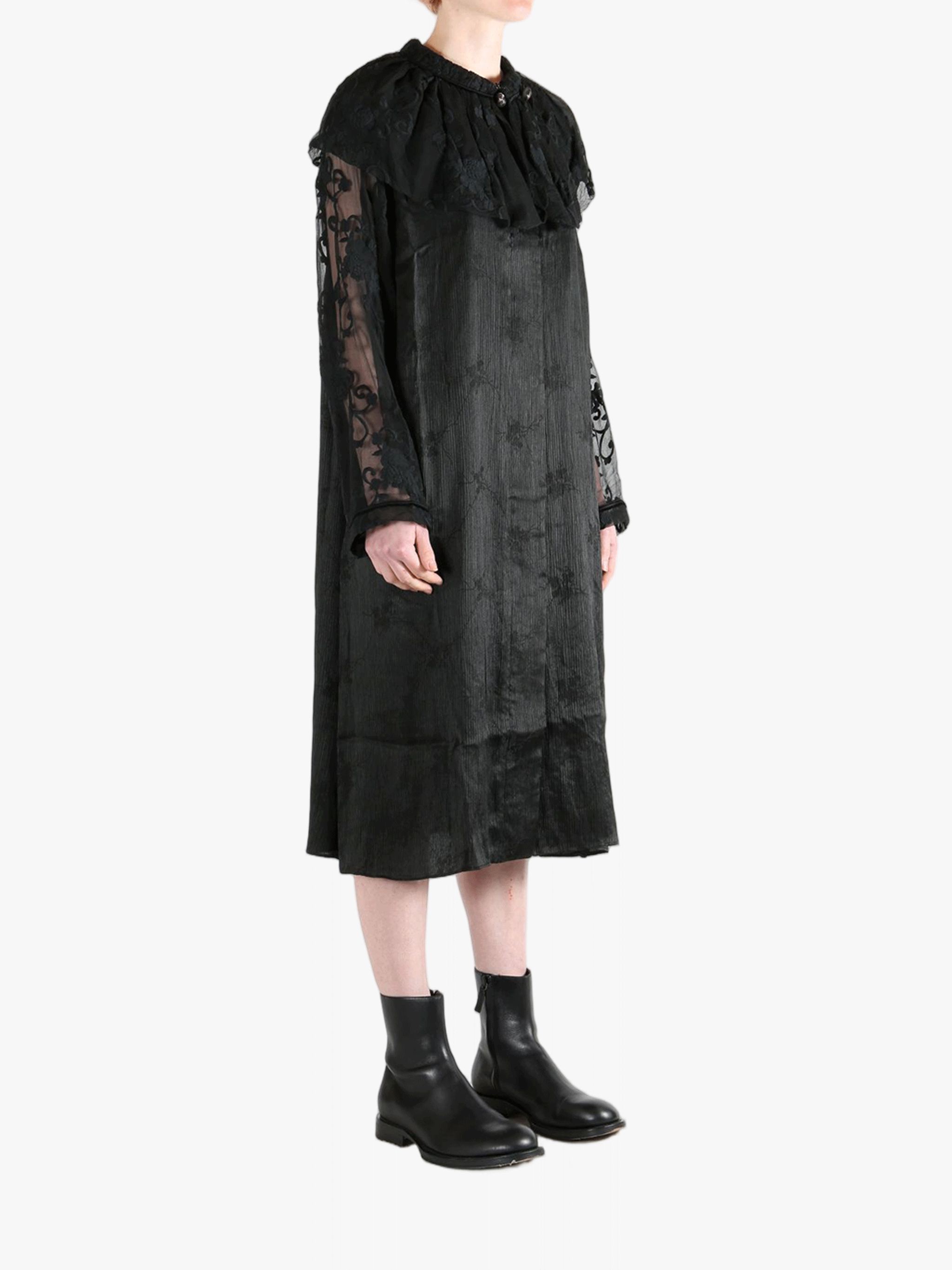 Black coats worn by a person, showing the coat's fit