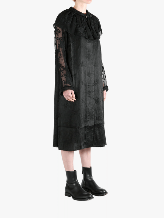 Black coats worn by a person, showing the coat's fit