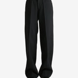 Black pants worn by a person, showing the pants fit