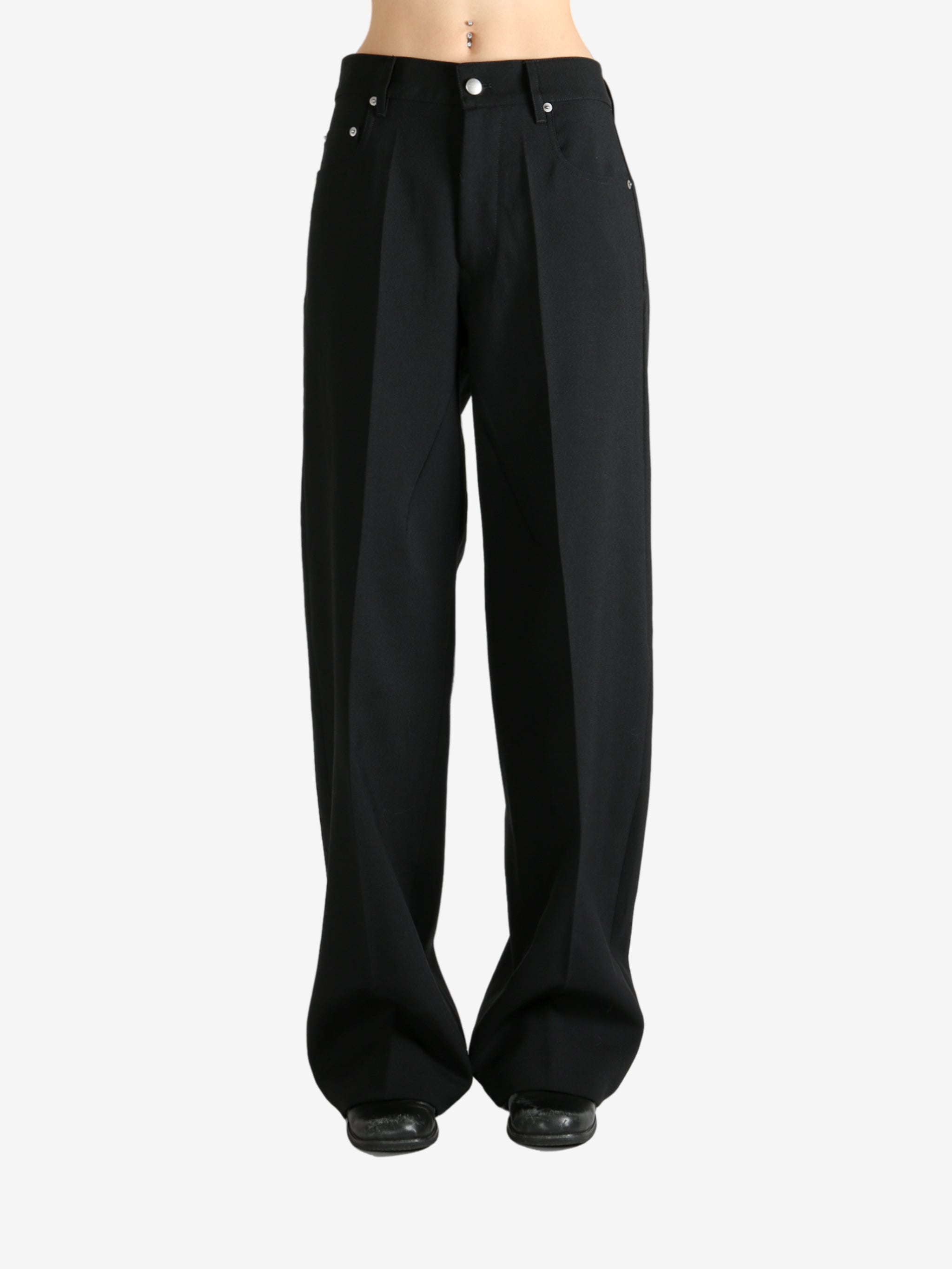 Black pants worn by a person, showing the pants fit