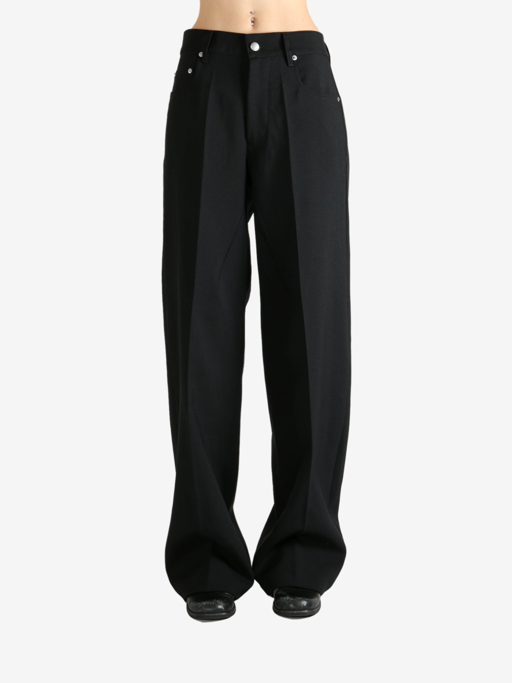 Black pants worn by a person, showing the pants fit