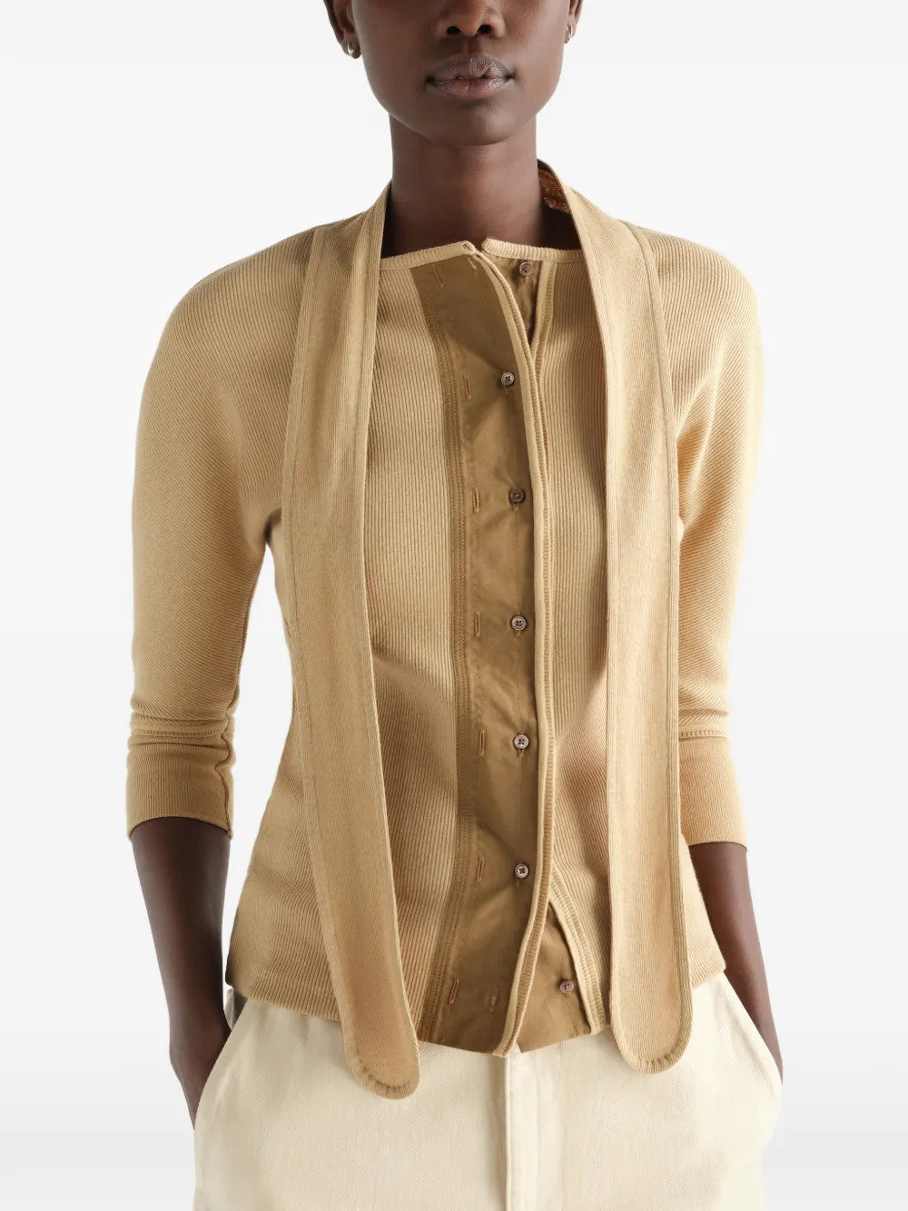 Tan shirt worn by a person, showing the shirt fit