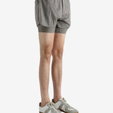 Grey shorts worn by a person, showing the shorts fit