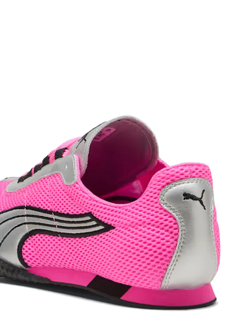 close up of pink sneakers, showing texture of the rubber fabric