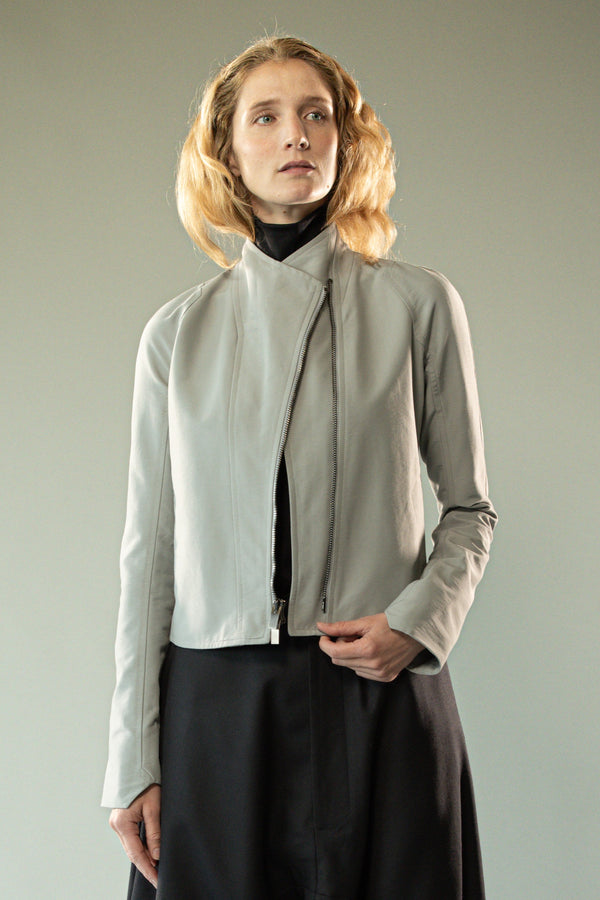 Grey jacket worn y a person, showing the jacket's fit