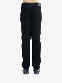 Black pants worn by a person, showing the pants's fit