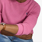 Pink knitwear worn by a person, showing the knitwear fit