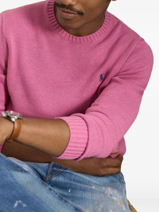 Pink knitwear worn by a person, showing the knitwear fit