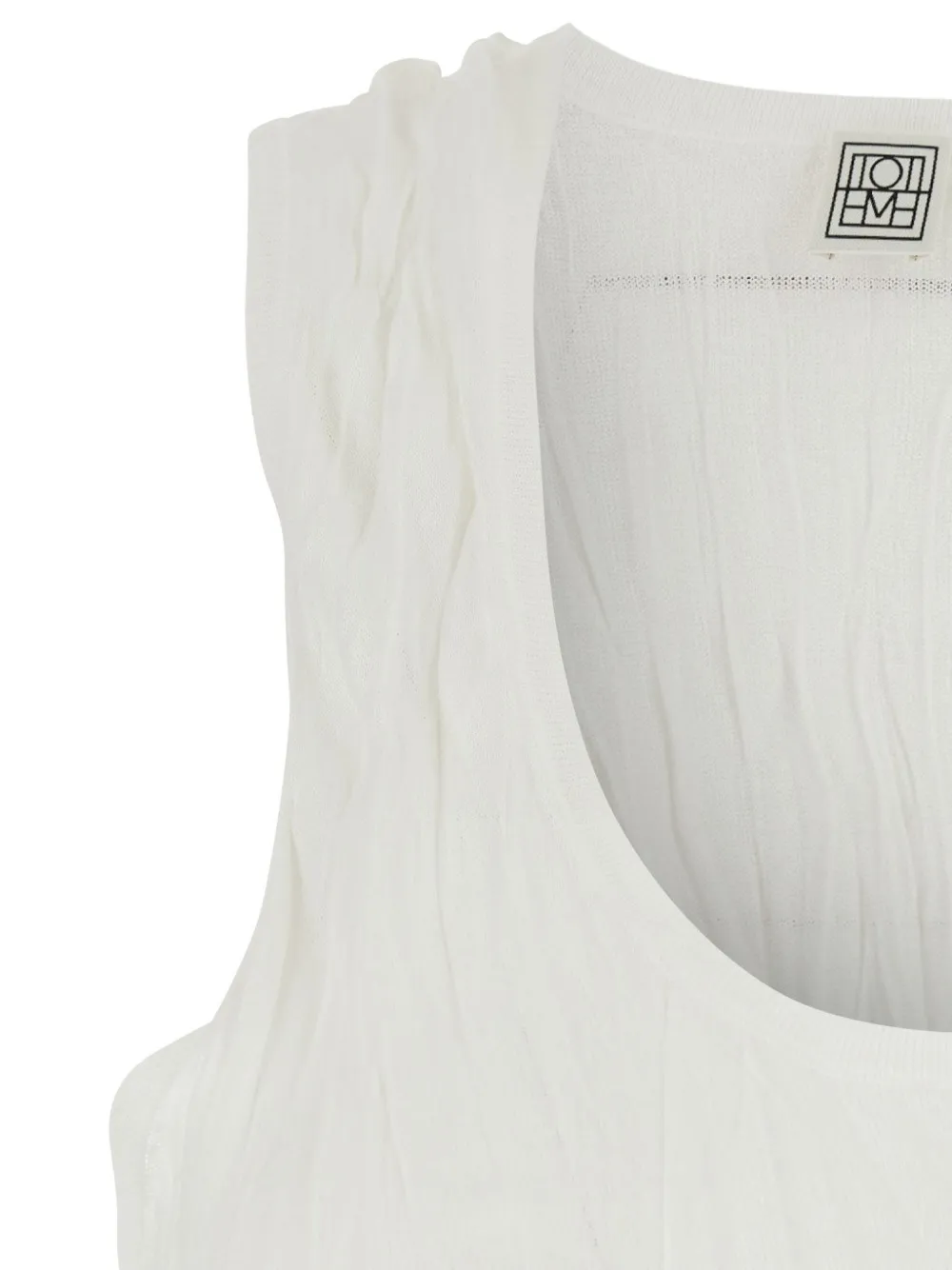 Close up of White top, showing texture of the 100% polyester fabric