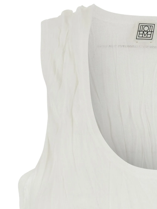 Close up of White top, showing texture of the 100% polyester fabric