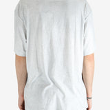 Grey t-shirt worn by a person, showing the shirt's fit