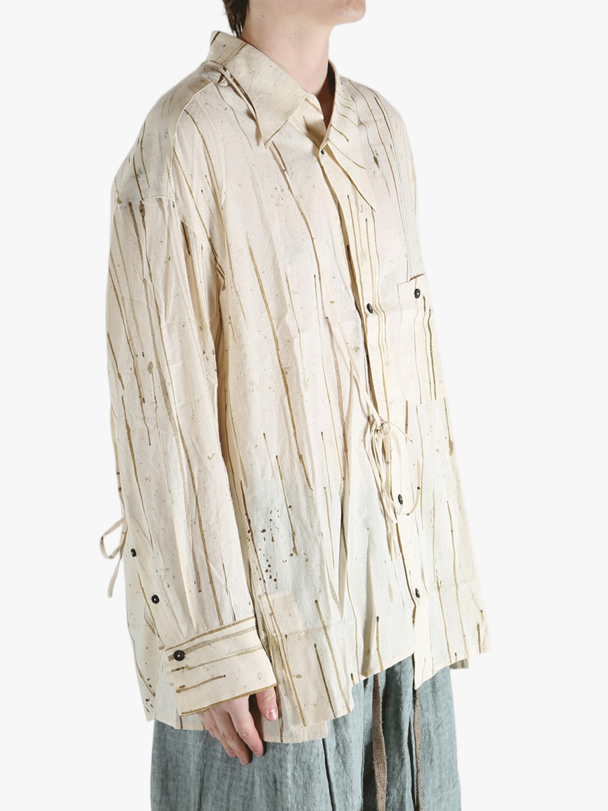 Tan shirt worn by a person, showing the shirt's fit