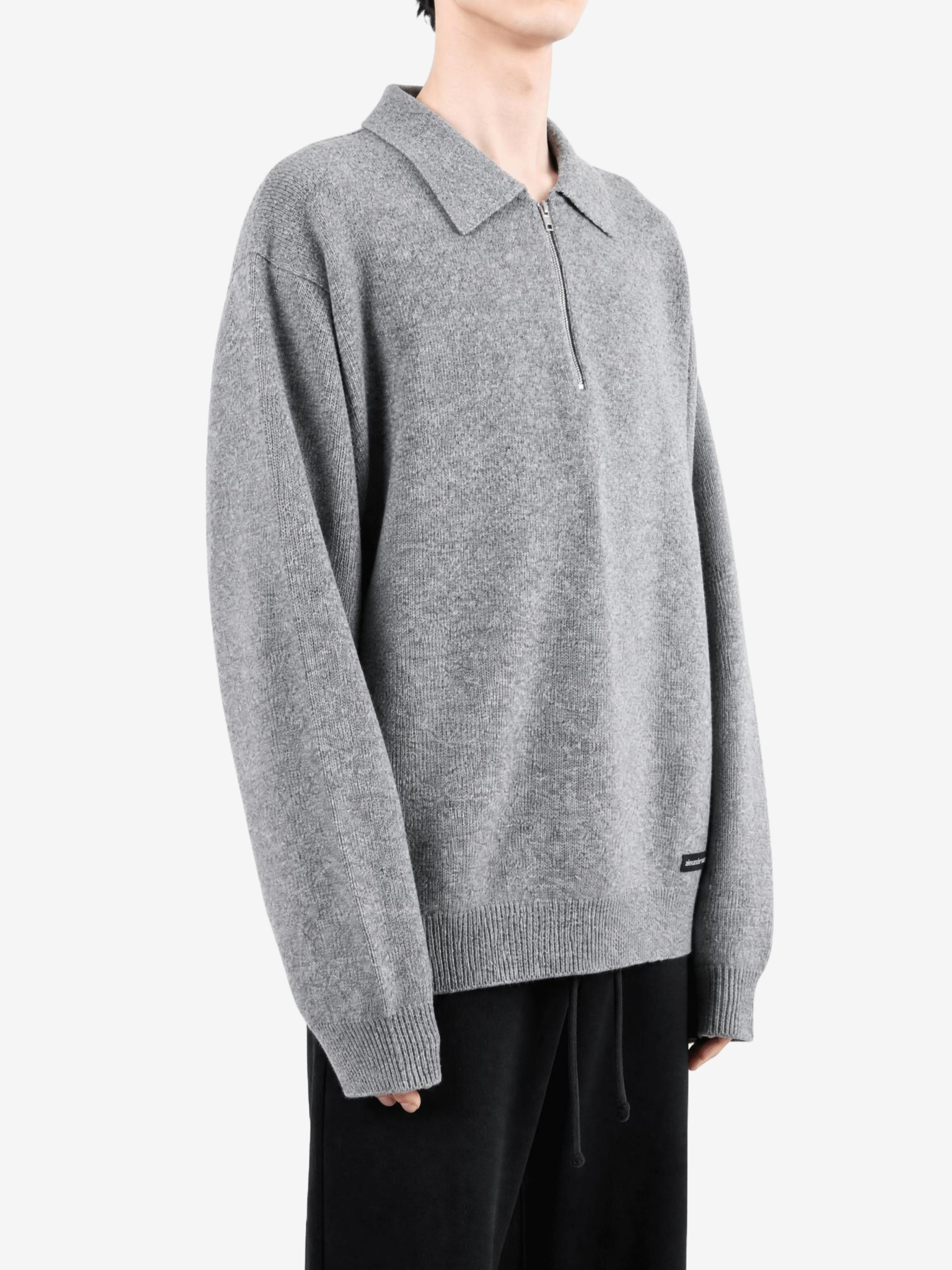 Grey top worn by a person, showing the top fit