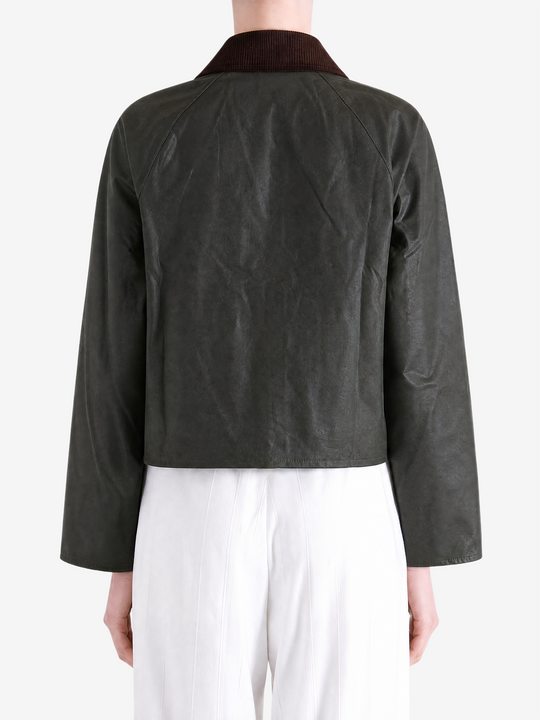 Green jacket worn by a person, showing the jacket fit