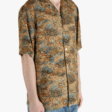 Tan shirt worn by a person, showing the fit