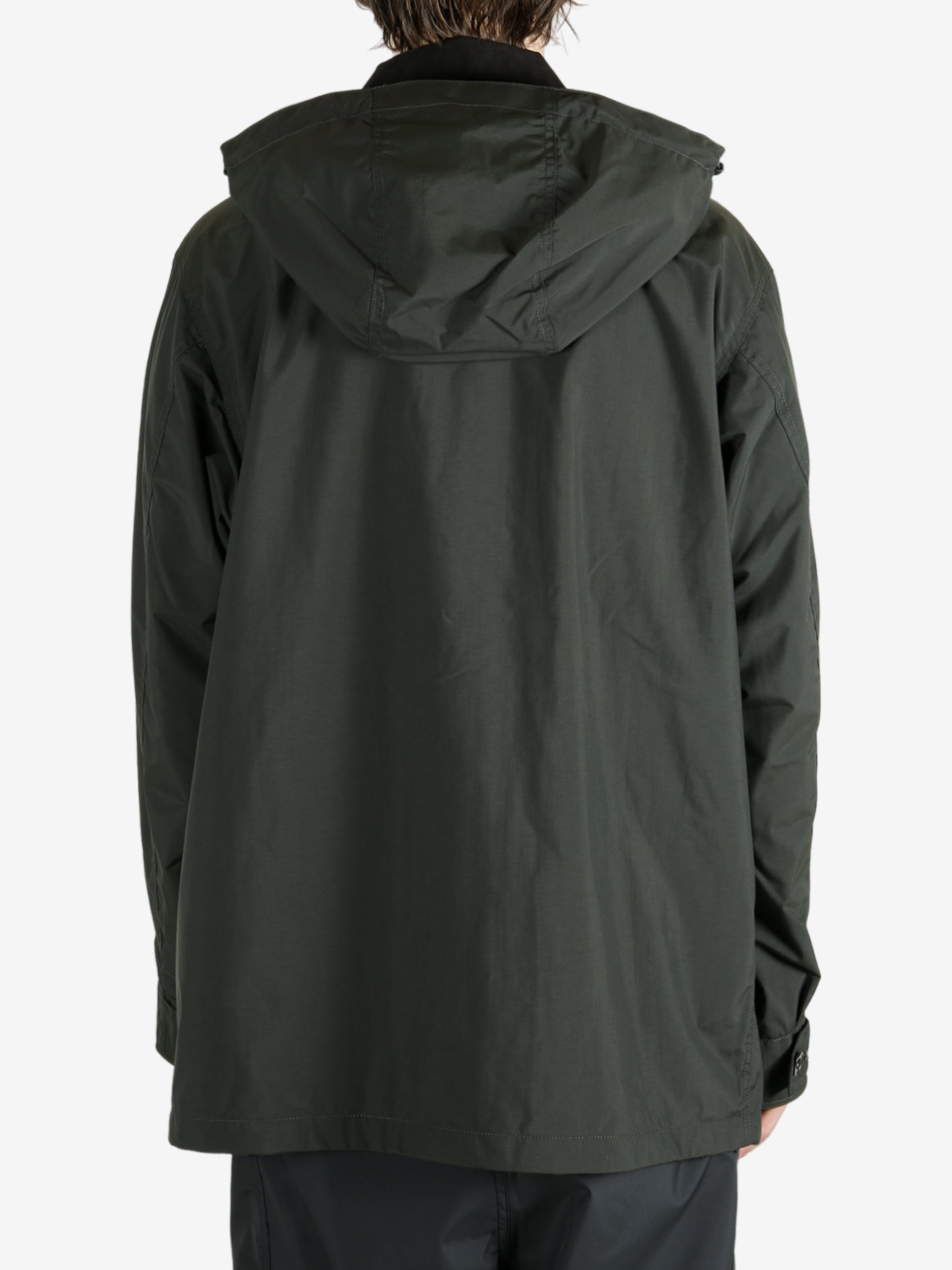 Green jackets worn by a person, showing the jacket’s fit