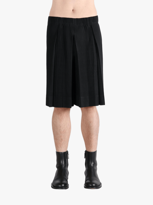 Black pants worn by a person, showing the  pants fit