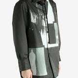 Black coat worn by a person, showing the coat's fit