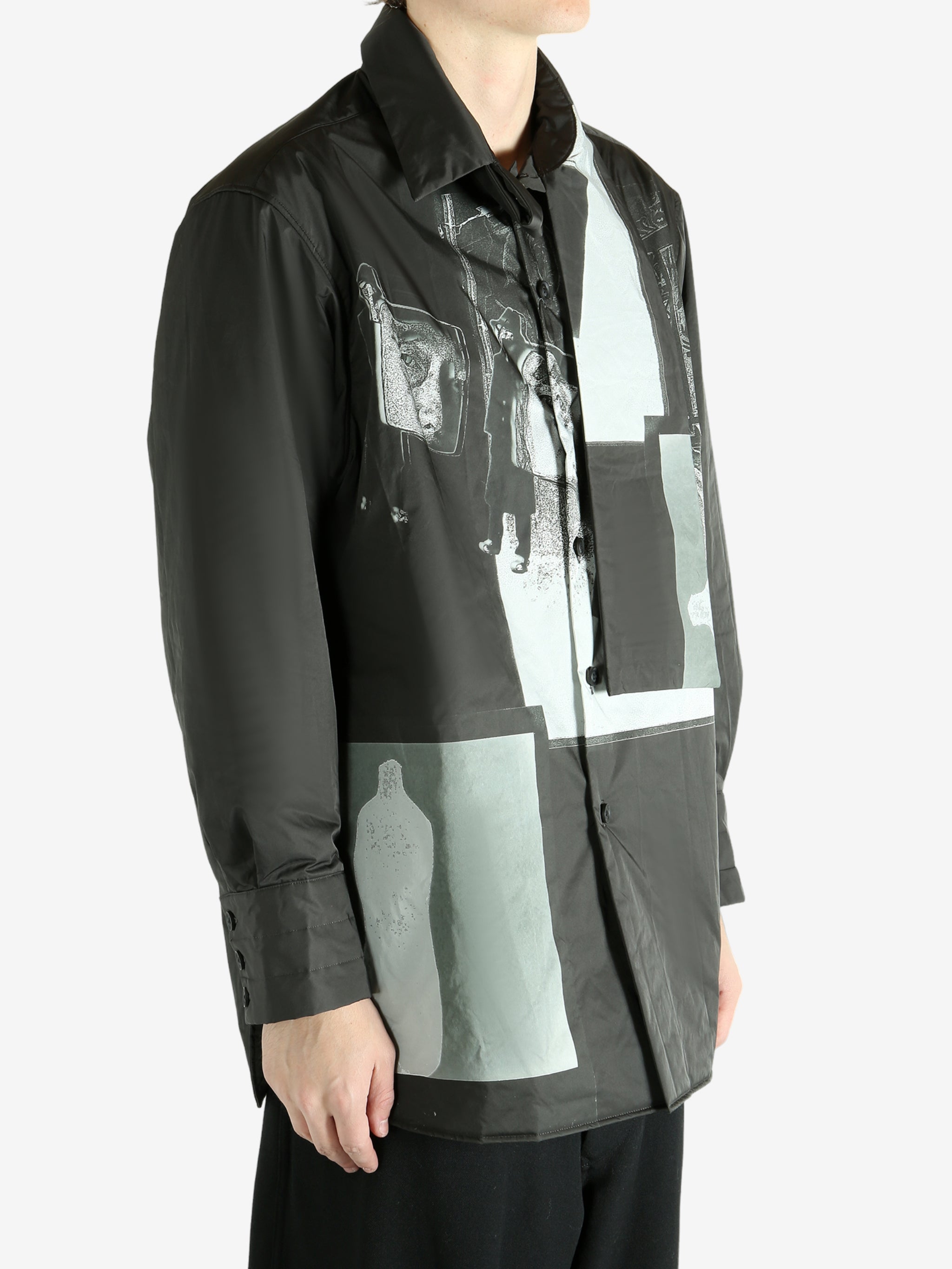 Black coat worn by a person, showing the coat's fit