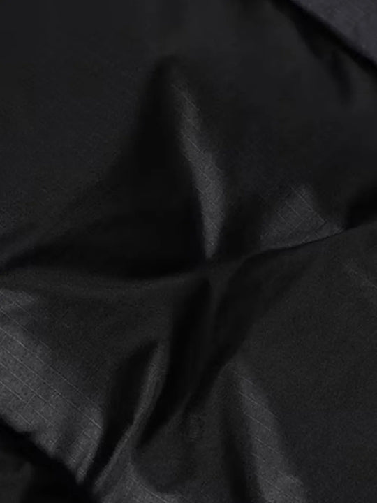 Close up of black jacket, showing texture of the nylon fabric