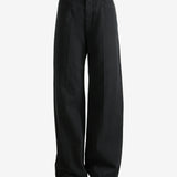 Black pants worn by a person, showing the pant's fit