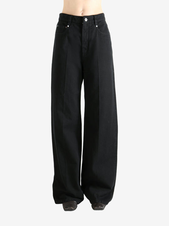 Black pants worn by a person, showing the pant's fit