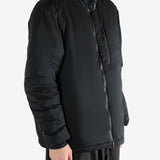 Black jacket worn by a person, showing the coat's fit